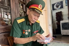 Đại tá Lê Kim Thơ (Cục Tham mưu Công binh, Bộ Tư lệnh Đoàn 559) lưu giữ cẩn thận cuốn sổ ghi chép ghi lại thời hoa lửa chiến đấu trên tuyến đường Trường Sơn huyền thoại. (Ảnh: Nguyên Linh/TTXVN)