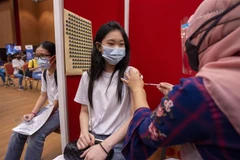 Nhân viên y tế tiêm vaccine ngừa COVID-19 cho thanh thiếu niên tại Selangor, Malaysia. (Ảnh: THX/TTXVN) 