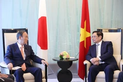 Thủ tướng Phạm Minh Chính tiếp cựu Thủ tướng Nhật Bản Suga Yoshihide. (Ảnh: Dương Giang/TTXVN) 