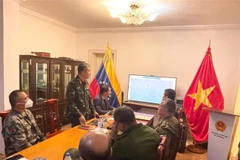 Tùy viên Quốc phòng Việt Nam tại Venezuela, Đại tá Vũ Thế Trung giới thiệu về Sách Trắng Quốc phòng của Việt Nam.(Ảnh: TTXVN phát)