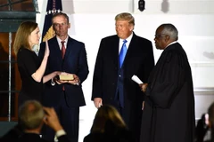 Bà Amy Coney Barrett (trái) tuyên thệ nhậm chức Thẩm phán Tòa án Tối cao trước sự chứng kiến của Tổng thống Mỹ Donald Trump (thứ 2, phải) tại Nhà Trắng ở Washington, DC. (Ảnh: AFP/TTXVN)