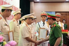 Thiếu tướng Nguyễn Thanh Tùng, Phó Giám đốc Công an thành phố Hà Nội trao các quyết định bổ nhiệm. (Ảnh: TTXVN phát)
