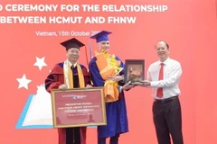 Phó Bí thư Thành ủy Thành phố Hồ Chí Minh Nguyễn Hồ Hải trao tặng tượng trưng công trình thanh niên 'Tủ sách Việt Nam' cho Giáo sư, tiến sỹ Andreas Hinz, Giám đốc Chương trình MBA của Khoa Kinh doanh, Đại học Khoa học Ứng dụng và Nghệ thuật Tây Bắc Thụy S