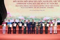 Thủ tướng Phạm Minh Chính và Bí thư Thành ủy Hà Nội Đinh Tiến Dũng trao danh hiệu 'Công dân Thủ đô Ưu tú' năm 2023 cho các cá nhân. (Ảnh: Dương Giang/TTXVN)