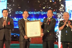 Đại tướng Lê Văn Dũng và Bộ trưởng Bộ Nội vụ Trần Văn Tuấn trao bằng công nhận thành phố Vị Thanh thuộc tỉnh Hậu Giang tối 28/9. (Ảnh: Duy Khương/TTXVN)