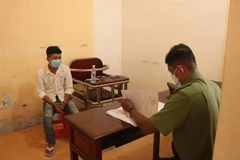 Đối tượng Lê Văn Giang tại cơ quan công an. (Ảnh: TTXVN phát)