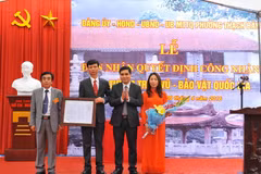 Cục phó cục Di sản trao quyết định công nhận pho tượng Trấn Vũ - Bảo vật quốc gia cho lãnh đạo phường Thạch Bàn - quận Long Biên. (Ảnh: Minh Đức/TTXVN)