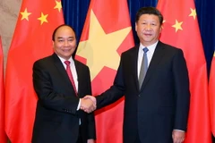 Thủ tướng Nguyễn Xuân Phúc hội kiến với Tổng Bí thư, Chủ tịch nước Trung Quốc Tập Cận Bình. (Ảnh: Thống Nhất/TTXVN)