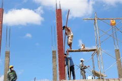 Công nhân làm nhà tại Khu tái định cư Lộc An-Bình Sơn. (Ảnh: Công Phong/TTXVN)