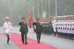 Đại tướng Lương Cường và Trung tướng Thongloi Silivong duyệt đội danh dự. (Ảnh: Dương Giang/TTXVN)