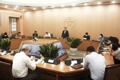 Cuộc họp của Ban Chỉ đạo phòng, chống dịch COVID-19 với các quận, huyện ngày 25/3. (Ảnh: PV/Vietnam+)
