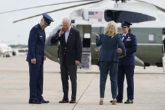 Tổng thống Joe Biden phủi một chú ve sầu đậu trên cổ áo, khi ông cùng đệ nhất phu nhân Jill Biden chuẩn bị lên máy bay Không lực Một, ngày 9/6/2021 tại Căn cứ Andrews. (Nguồn: apnews.com)