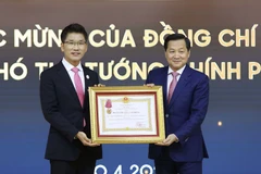 Phó Thủ tướng Chính phủ Lê Minh Khái phủ trao Huân chương Lao động hạng Ba cho Công ty TNHH Điện tử Samsung Việt Nam Thái Nguyên. (Ảnh: An Đăng/TTXVN)