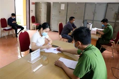 Công an thị trấn Đông Anh, huyện Đông Anh hướng dẫn người dân thực hiện các thủ tục liên quan đến Luật Cư trú mới. (Ảnh minh họa: Phạm Kiên/TTXVN)