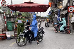 Lực lượng công an kiểm tra giấy tờ của người dân tại chốt cửa khẩu Hàm Tử Quan. (Ảnh: Văn Cảnh/TTXVN)