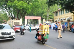 Cảnh sát giao thông phân luồng phương tiện trước cổng Trường Trung học Phổ thông Chu Văn An. (Ảnh: Hoài Nam/Vietnam+)