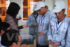 Lao động làm thủ tục trước khi đi làm việc ở nước ngoài. (Ảnh: PV/Vietnam+)