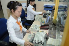 Hơn 70% người dân nhận kiều hối chuyển sang VND. (Ảnh: Vietnam+)