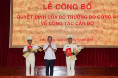 Đồng chí Lữ Văn Hùng, Ủy viên Trung ương Đảng, Bí thư Tỉnh ủy Hậu Giang tặng hoa chúc mừng Thượng tá Huỳnh Việt Hòa và Đại tá Phan Hoàng Lắm. (Ảnh: Hồng Thái/TTXVN)