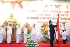 Chủ tịch nước Trần Đại Quang tới dự Lễ kỷ niệm 35 năm Ngày thành lập và trao tặng Huân chương Bảo vệ Tổ quốc hạng Nhất cho Cục Bảo vệ Chính trị II, Tổng cục An ninh, Bộ Công an. (Ảnh: Nhan Sáng/TTXVN)