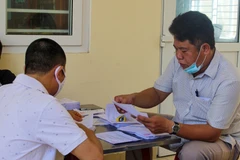 Người dân nhận tiền trợ cấp từ gói hỗ trợ 62.000 tỷ đồng.(Ảnh minh họa: TTXVN)