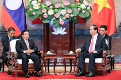 Chủ tịch nước Trần Đại Quang tiếp ông Phankham Viphavan, Ủy viên Bộ Chính trị, Thường trực Ban Bí thư, Phó Chủ tịch nước Lào. (Ảnh: Nhan Sáng/TTXVN)