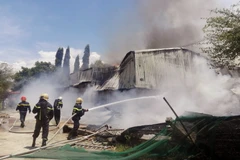 Lực lượng Cảnh sát Phòng cháy chữa cháy nỗ lực dập tắt đám cháy. (Ảnh: Công Thử/TTXVN)