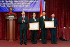 Chủ tịch nước Trần Đại Quang trao tặng Huân chương Lao động hạng Nhất cho Đại sứ Nguyễn Thanh Sơn và Huân chương Lao động hạng Nhì cho Đại sứ quán Việt Nam tại Liên bang Nga. (Ảnh: Nhan Sáng/TTXVN)