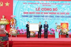 Thừa ủy quyền, đồng chí Nguyễn Văn Danh (thứ hai, từ phải sang), Ủy viên Trung ương Đảng, Bí thư Tỉnh ủy Tiền Giang trao Nghị quyết thành lập thành phố Gò Công cho Đảng bộ, chính quyền và nhân dân Gò Công. (Ảnh: Hữu Chí/)TTXVN