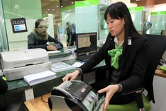 "Ngân hàng Nhà nước cần đưa ra một chính sách nới lỏng room tín dụng một cách hợp lý, linh hoạt, công bằng, minh bạch." (Ảnh: TTXVN)