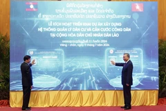 Chủ tịch nước Tô Lâm và Tổng Bí thư, Chủ tịch nước Lào Thongloun Sisoulith thực hiện nghi thức kích hoạt triển khai dự án Xây dựng hệ thống quản lý dân cư và căn cước công dân tại Lào. (Ảnh: Nhan Sáng/TTXVN)