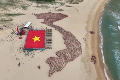 Đoàn viên thanh niên và học sinh tỉnh Phú Yên xếp hình bản đồ đất nước với hai quần đảo Hoàng Sa và Trường Sa bên cạnh cờ Tổ quốc. (Ảnh: TTXVN phát)