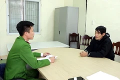 Đối tượng Trần Văn Lợi làm việc với cơ quan Công an. (Ảnh: TTXVN phát)