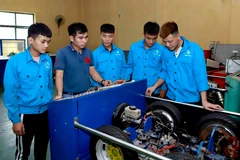 Giáo viên khoa Động lực Trường Cao đẳng nghề Vĩnh Phúc hướng dẫn cho sinh viên cơ chế hoạt động của hệ thống phanh ABS trên ôtô. (Ảnh: Hoàng Hùng/TTXVN)