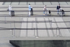 Hành khách thực hiện giãn cách xã hội phòng lây nhiễm COVID-19 tại sân bay Heathrow ở London, Anh, ngày 1/5/2020. (Ảnh: THX/TTXVN)