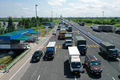 Các phương tiện dừng để thực hiện khai báo tại chốt kiểm soát cầu Bạch Đằng (Quảng Ninh). (Ảnh: TTXVN phát)