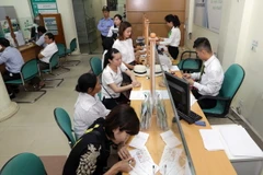 Khách hàng giao dịch tại Vietcombank chi nhánh Bắc Giang. (Ảnh: Trần Việt/TTXVN)