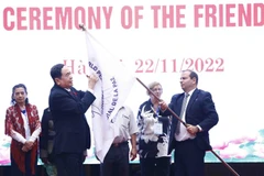 Phó Chủ tịch thường trực Quốc hội Trần Thanh Mẫn ký lên lá cờ của Hội đồng Hòa bình thế giới. (Ảnh: Minh Đức/TTXVN)