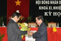 Ông Nguyễn Thanh Tùng, Chủ tịch HĐND tỉnh Bình Định khóa XI tặng hoa cho ông Vũ Hoàng Hà, Chủ tịch HĐND tỉnh khóa X. (Ảnh: baobinhdinh)