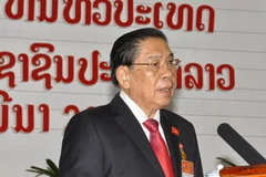 Tổng bí thư Đảng Nhân dân Cách mạng Lào, Chủ tịch nước Lào Choummaly Saysasone đọc báo cáo chính trị tại lễ khai mạc đại hội. (Ảnh: THX/TTXVN)