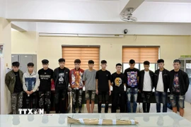 Nhóm đối tượng cùng tang vật tại cơ quan Công an. (Ảnh: TTXVN phát)