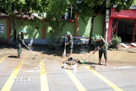 Các cán bộ chiến sỹ Bộ Chỉ huy Quân sự tỉnh Lạng Sơn giúp người dân Thất Khê dọn dẹp vệ sinh. (Ảnh: Văn Đạt/TTXVN)