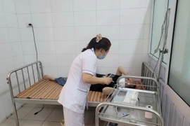 Thăm khám cho người bệnh nghi ngộ độc sau khi được chuyển cấp cứu, điều trị tại Trung tâm Y tế Hương Trà. (Nguồn: Tiên Phong)