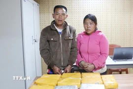 Hai đối tượng Mùa A Cú và Thào Thị Ly cùng tang vật tại cơ quan Công an. (Ảnh: TTXVN phát)