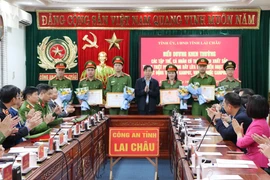 Chủ tịch Ủy ban Nhân dân tỉnh Lai Châu Lê Văn Lương tặng Bằng khen cho 14 cá nhân có thành tích xuất sắc trong thực hiện Chuyên án 0525L. (Ảnh: Nguyễn Oanh/TTXVN)