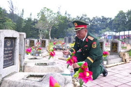 Thiếu tướng Thiếu tướng Trần Chí Tâm, Phó Chính ủy Quân khu 7, Trưởng Ban chỉ đạo 515 Quân khu 7, thắp hương lên các phần mộ liệt sĩ tại Nghĩa nghĩa trang Đồi 82. (Ảnh: Minh Phú/TTXVN)