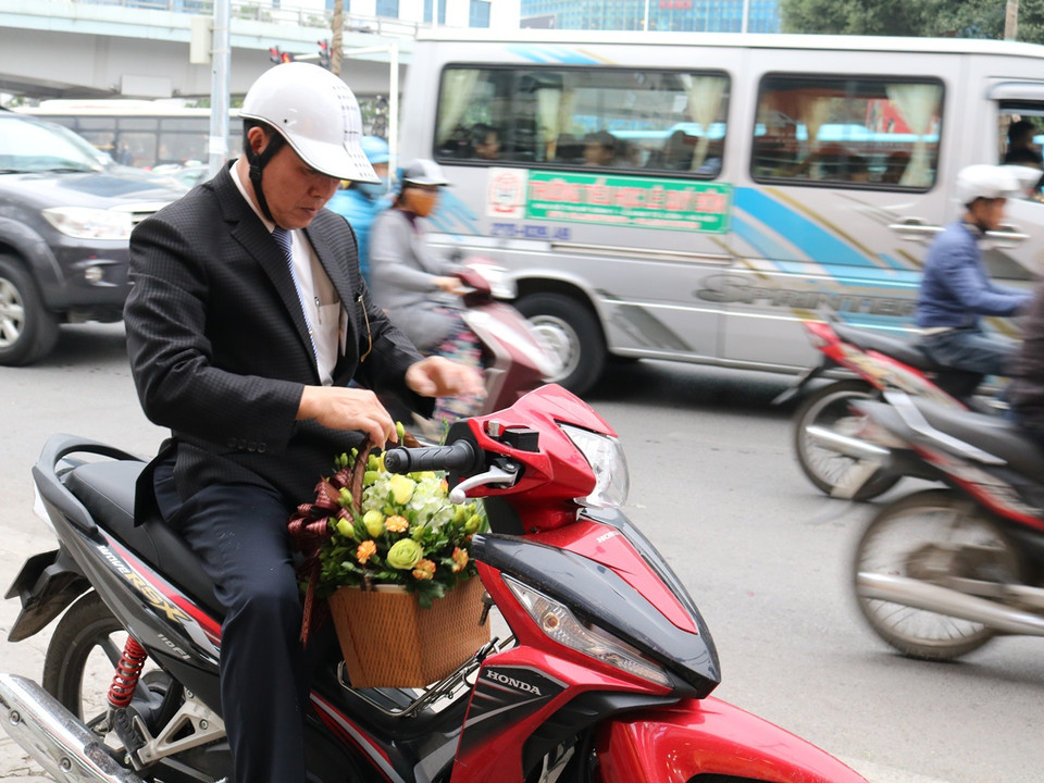 Ngày 8/3 là dịp để các "đấng mày râu" mua hoa tặng những người phụ nữ thân yêu. (Ảnh: Nam Giang/Vietnam+)