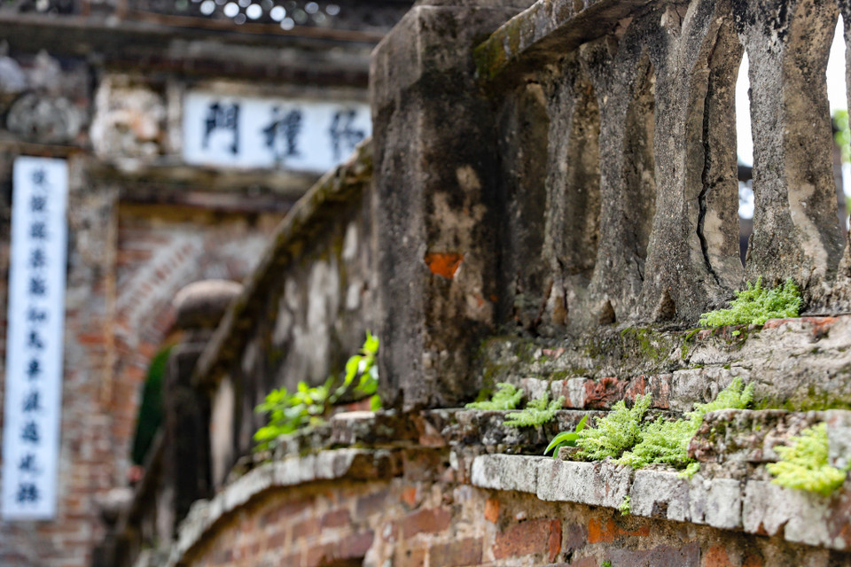 Ngay từ đầu làng, chiếc cầu gạch cong cong duyên dáng bắc qua con sông nhỏ và cổng làng bề thế với dòng chữ Hán "Ước Lễ thôn" đưa ta vào không gian của làng cổ. (Ảnh: Hoài Nam/Vietnam+)