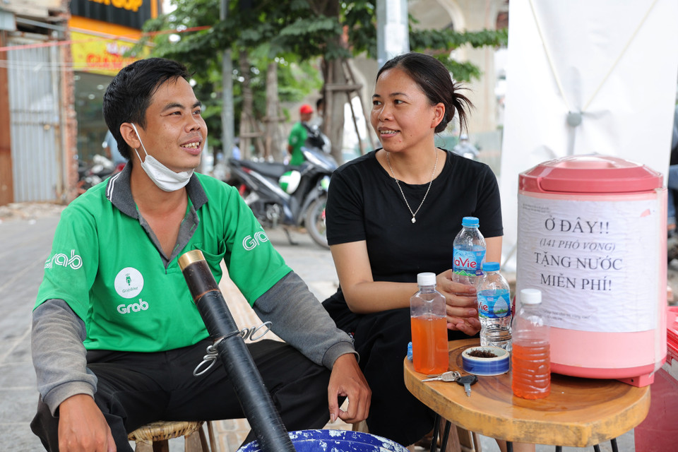 Anh Thịnh chạy xe ôm, thường xuyên phải di chuyển ngoài đường lúc nắng nóng, tâm sự: 'Đây là việc thiện, tôi cảm thấy rất phấn khởi khi có những người như gia đình chị Hương.' (Ảnh: Hoài Nam/Vietnam+)