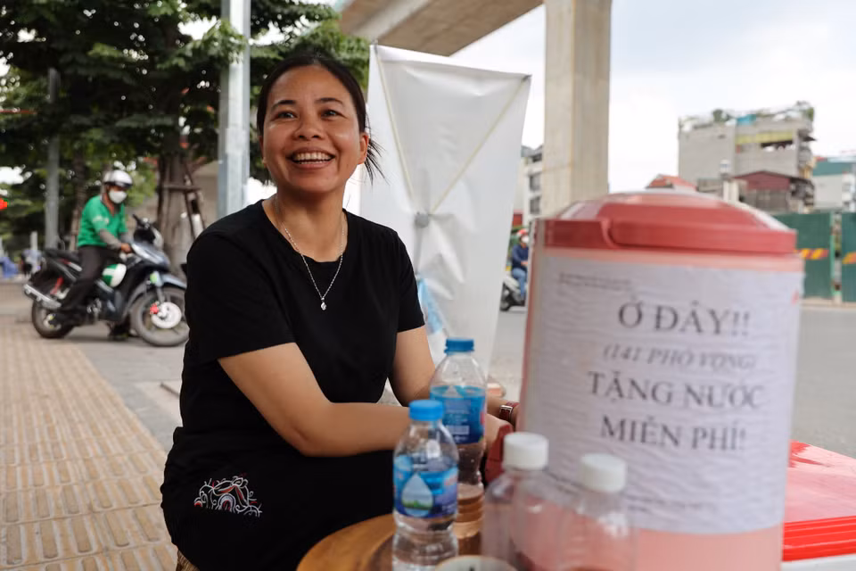 Niềm vui của người đi đường cũng là niềm vui của chị Hương khi giúp đỡ được người khác. Chị mong rằng tại các ngã tư khác cũng sẽ có những 'cây ATM' nước miễn phí để giúp đỡ người đi đường. (Ảnh: Hoài Nam/Vietnam+)